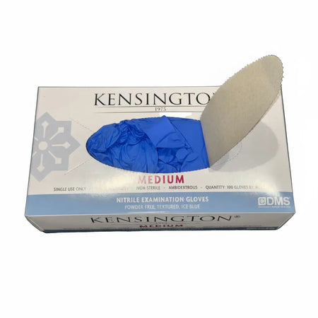 Medical professional wearing Kensington 1975® nitrile examination gloves with branded box visible in clinical setting