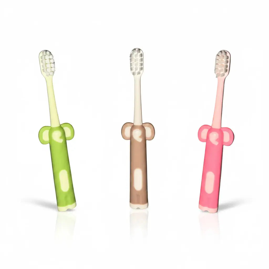 Three Kids Ultra Soft Toothbrushes with ultra-soft bristles, elephant-shaped easy-grip handles and free-standing bases in assorted green, beige and pink colours on a white background.