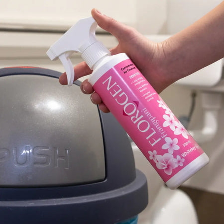 Whiteley Florogen Frangipani 500mL surface deodorant being sprayed onto a bin for odour control